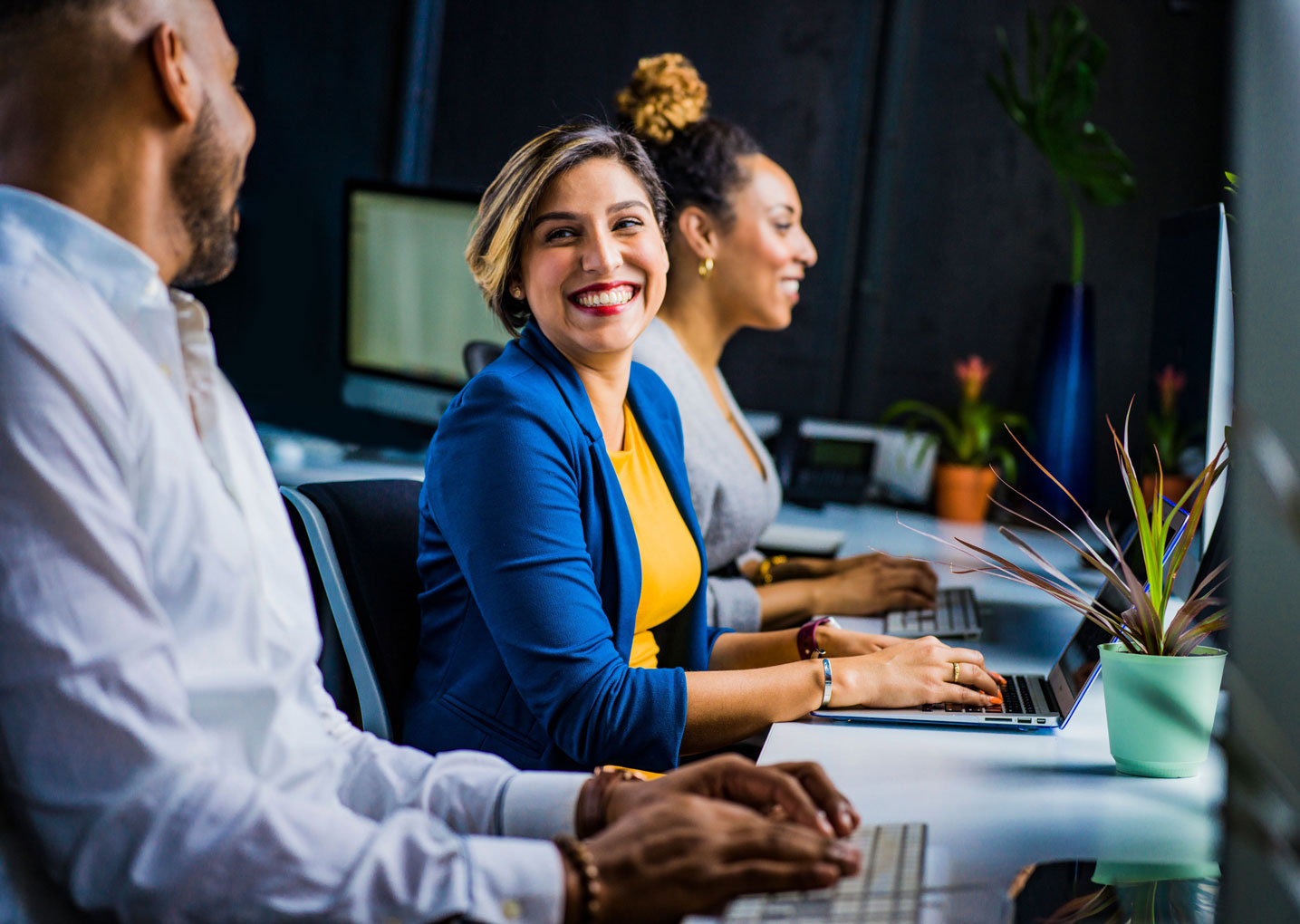 female business person smiling at coworker