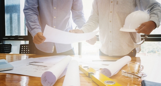 two engineers reviewing construction plan